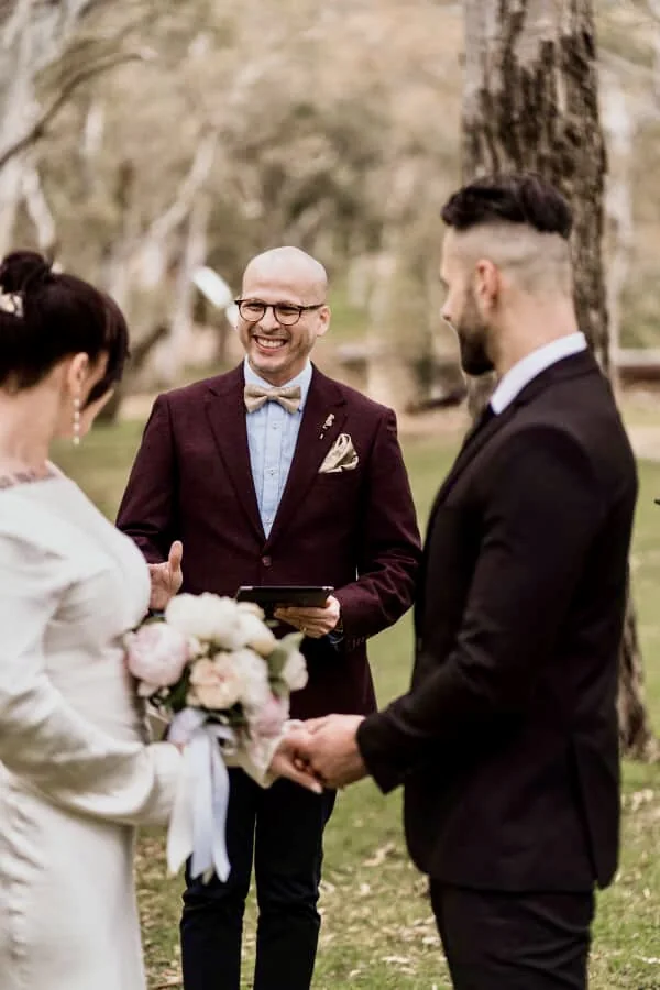 Andrés leading a ceremony for a couple among the gum trees