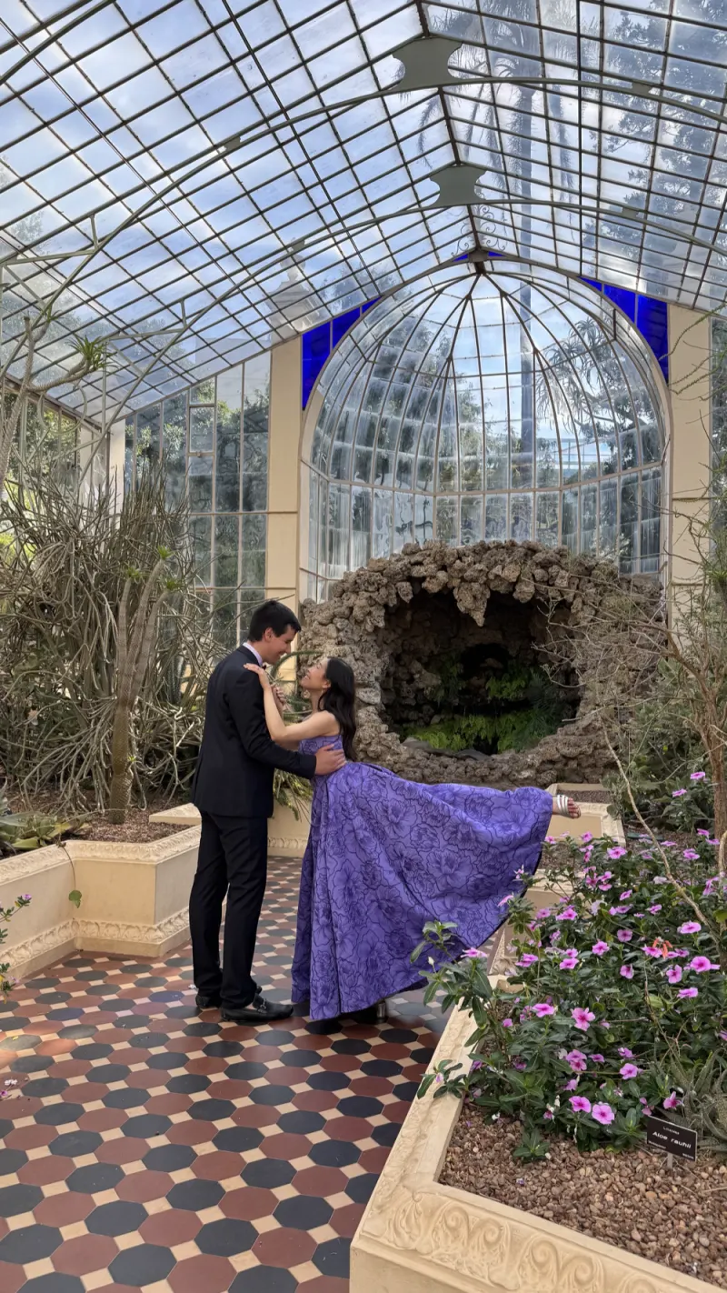 A couple sharing a quiet moment inside a heritage glasshouse